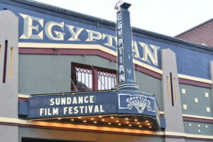 The words Sundance Film Festival appear on the Egyptian Theatre marquee. The sky is overcast.